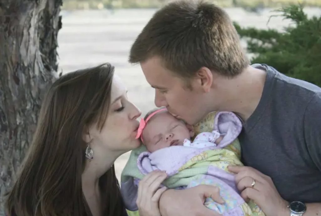 Darci and Chris with their daughter.